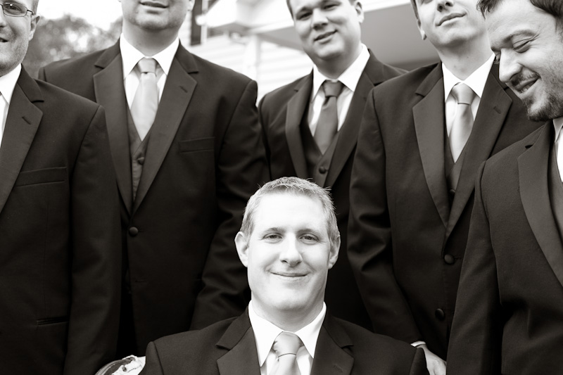 Groom with his groomsmen before their fall wedding ceremony at Morris Arboretum, a unique garden venue.