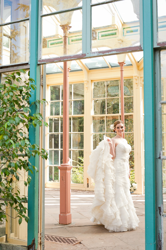Portraits of the bride inside a rustic greenhouse at Rockwood Carriage House in Delaware.
