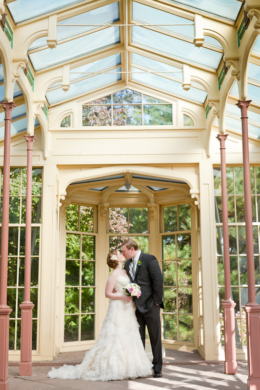 Bride and groom portraits in the rustic, romantic greenhouse at Rockwood Carriage House in Delaware.
