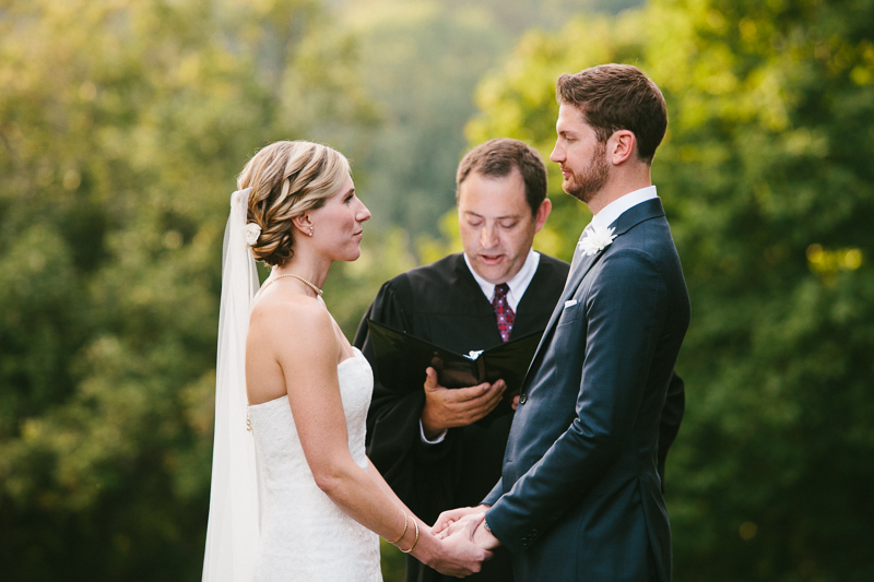 Bride and groom tie the knot at their outdoor fall wedding ceremony at Morris Arboretum in Philadelphia.