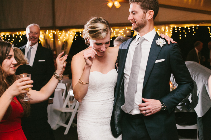 Bride and groom celebrate and dance during their modern garden wedding reception in Philly.