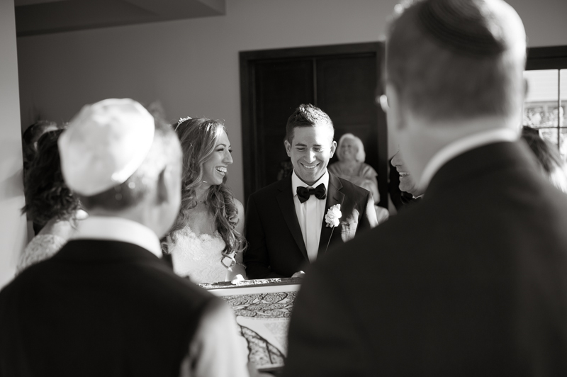 Bride and groom sign the ketubah with all of their family at the rustic Lake House Inn.