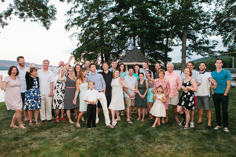 Family and friends during an outdoor rustic-glam wedding rehearsal dinner in New York.