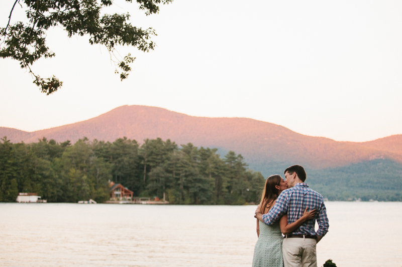 Future bride and groom alongside Lake George watching the sunset in New York.