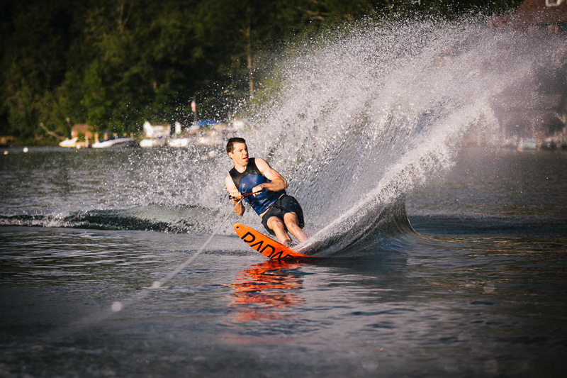 Groom waterskis before his fall wedding ceremony at Lake George in New York.