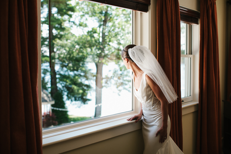 Bride gets ready before her rustic outdoor wedding ceremony at Lake George in New York.