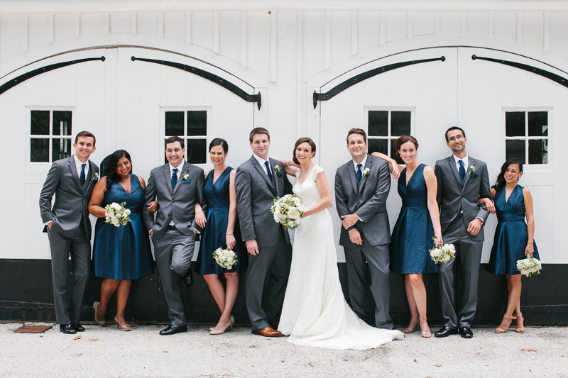 Bridal party in navy blue and white take outdoor portraits at Appleford Estate.