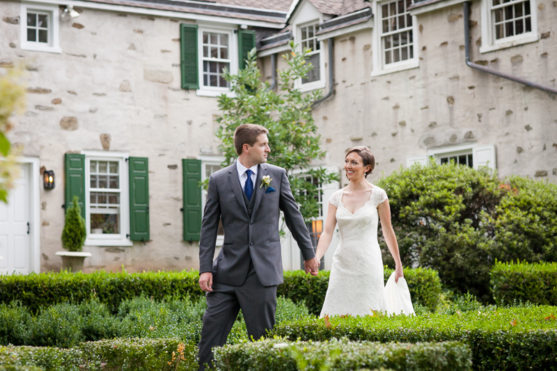 Bride and groom walk through the gardens of Appleford, a unique estate venue on the Main Line of PA.