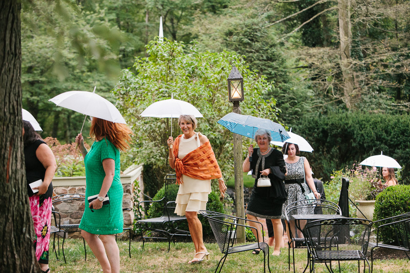 Guests enter for the wedding reception at Appleford estate on a rainy, fall day.