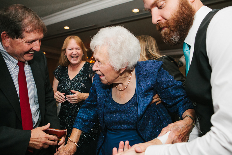 Grandma dances with her family at her granddaughters wedding reception at the Overbrook Golf Club in Villanova, PA.
