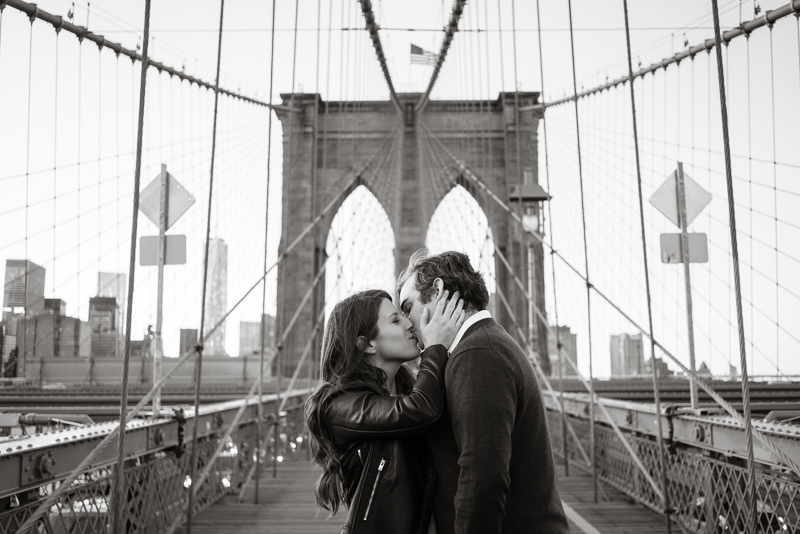 Future bride and groom on the brooklyn bridge for their offbeat, artistic engagement session.