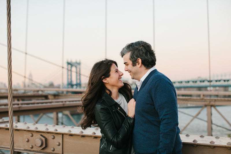 Romantic sunset portraits of the future bride and groom on the Brooklyn bridge in Dumbo.