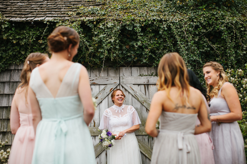 A vintage inspired bride laughs with her bridesmaids at Terrain at Styers.