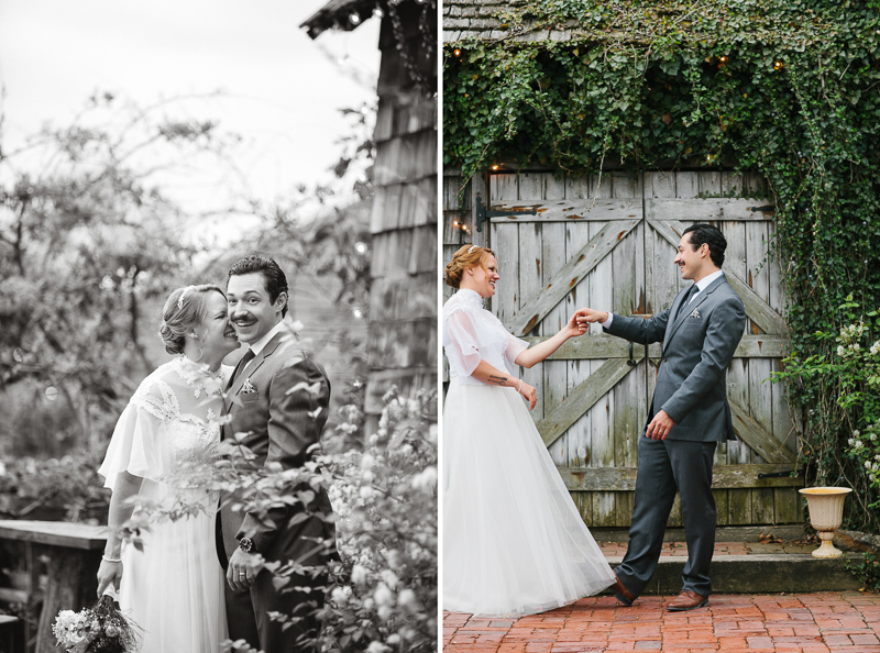 Bride and groom pose in front of rustic garden doors at their outdoor spring wedding near Philadelphia.
