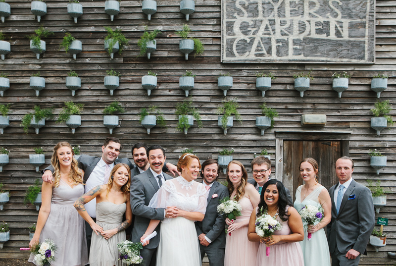 A candid portrait of the bridal wedding party outside of Styer's Garden Cafe at Terrain near Philadelphia.