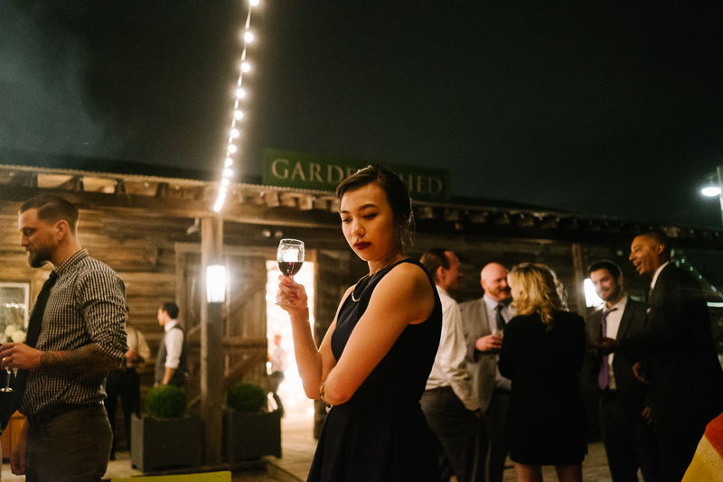 Guests congregate outdoors under the lights at night at Terrain during a spring wedding.