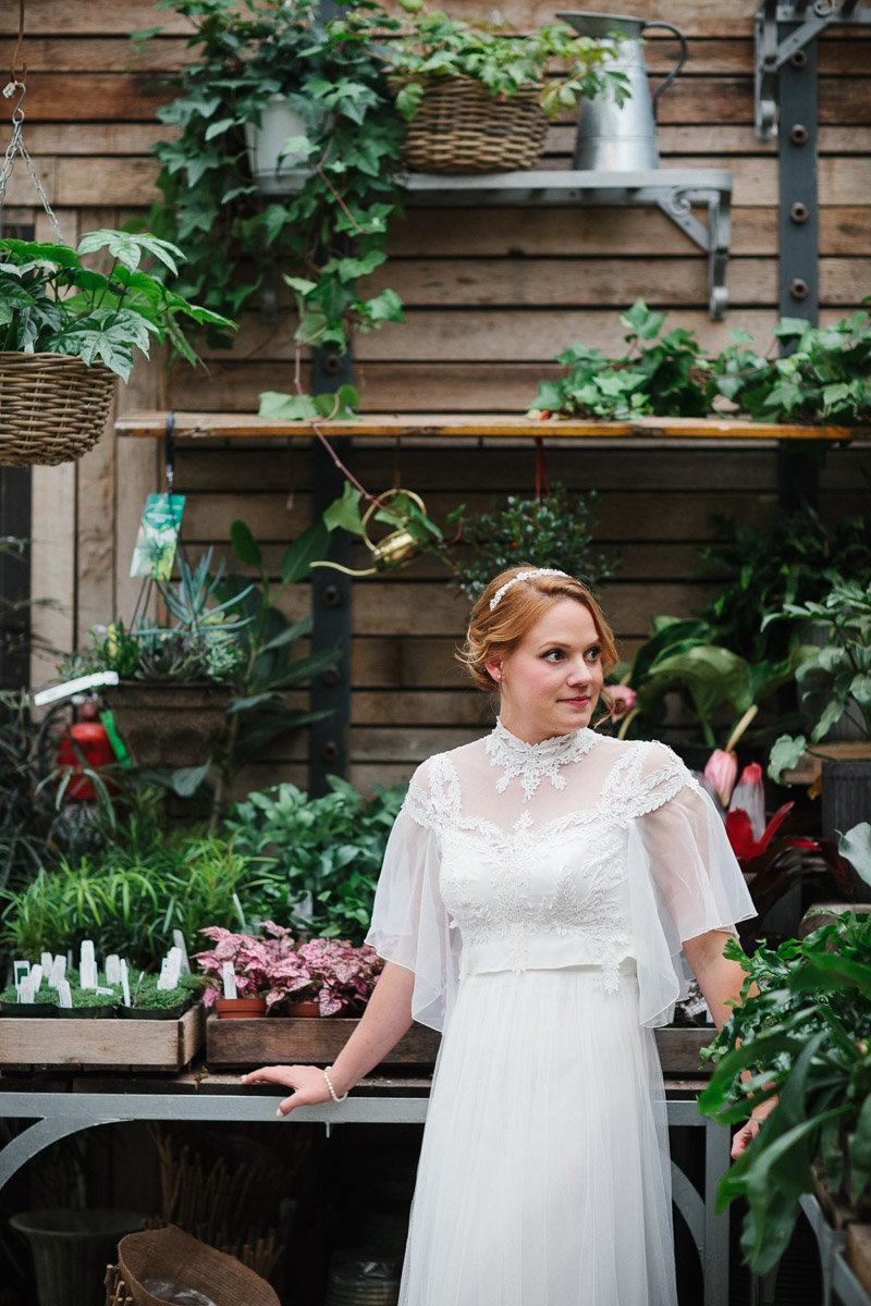 Bride gets cozy in the greenhouse at Terrain at Styers in Pennsylvania.