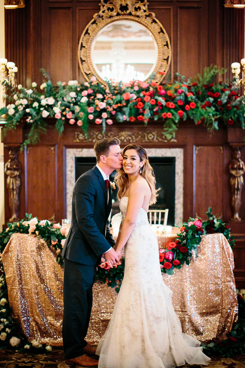 Bride and groom pose in their reception room of their Philadelphia wedding.