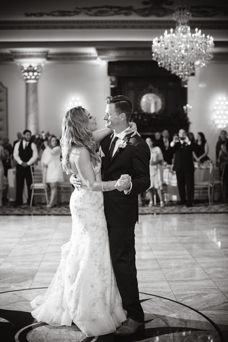 The bride and groom have their first dance during their wedding reception.