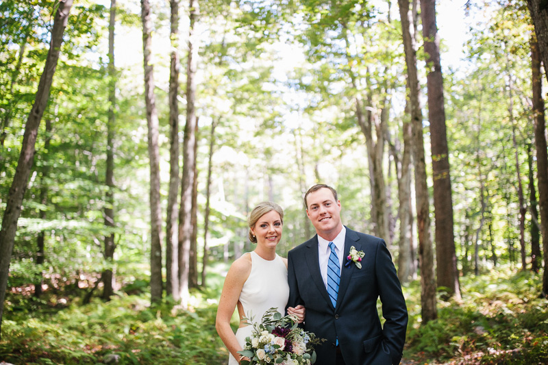 Portrait of the bride and groom outdoors in the Pocono Pines near Lake Naomi.