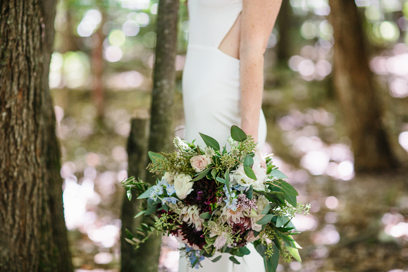 Gorgeous jewel-toned bridal bouquets complement this outdoor forest wedding.