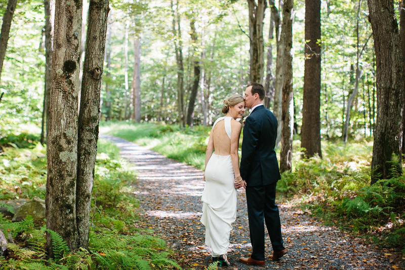 Portrait of the bride and groom outdoors in the Poconos, PA, before their wedding ceremony at Lake Naomi.