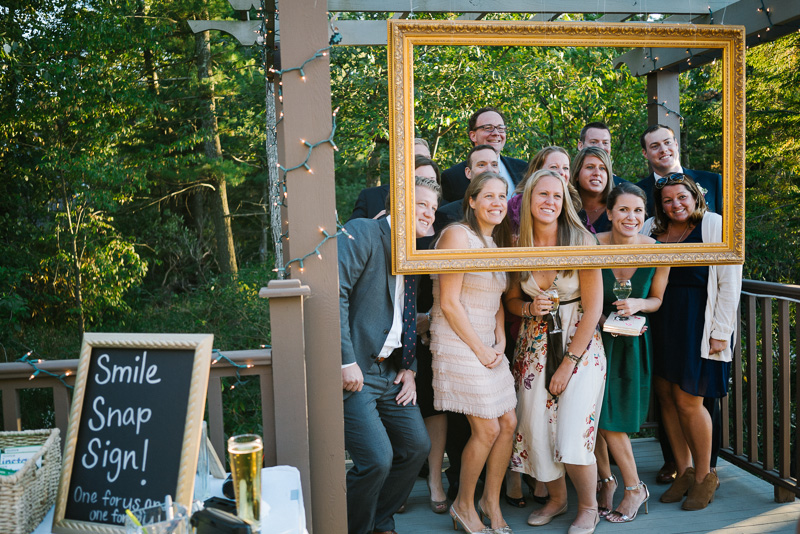 A unique and rustic wedding reception featuring this fun photo booth.