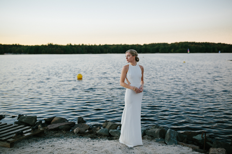 This modern bride poses for unique sunset portraits on the shore of Lake Naomi, Pocono Pines, PA.