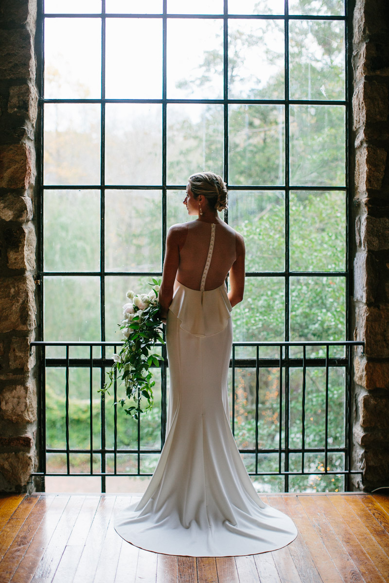 Hollyhedge Estate wedding photo of bride in barn in front of windows in Bucks County