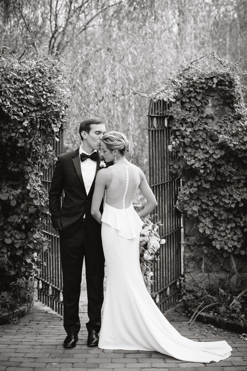 wedding photo bride and groom in stone courtyard garden at Hollyhedge estate