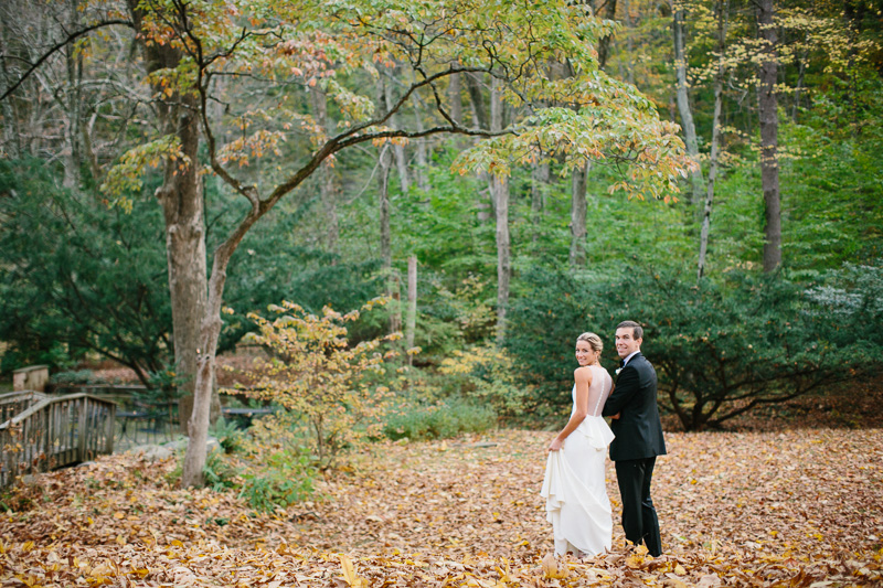 wedding photo bride and groom by pond and fall trees at Hollyhedge estate