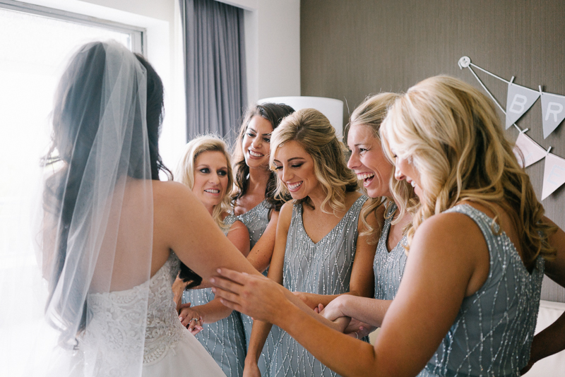 Bride gets ready with her bridesmaids for her wedding reception at the Sky Philadelphia, a venue with breathtaking cityscape views.