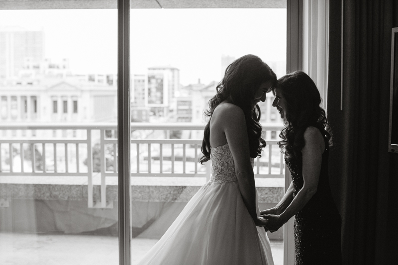 Bride with her mom before her modern wedding at the Sky Philadelphia, a venue with a unique perspective of the Philadelphia city skyline.