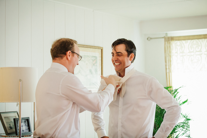 Groom gets ready before his wedding ceremony in tropical Hawaii.