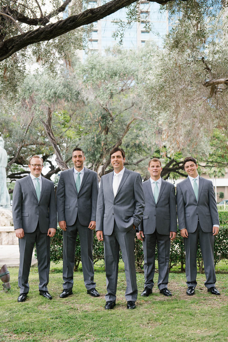 Outdoor portraits of the groom with his groomsmen during their wedding day on Oahu, Hawaii.