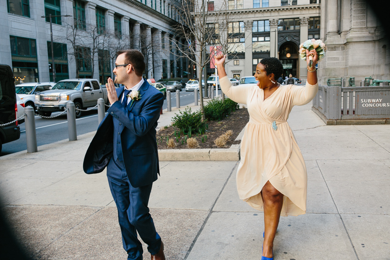 Couple walks around City Hall taking portraits, photography by Sweetwater Portraits.