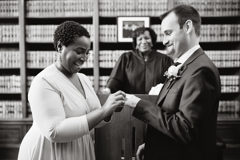 Elopement couple exchange rings during their wedding ceremony at City Hall in Philadelphia.