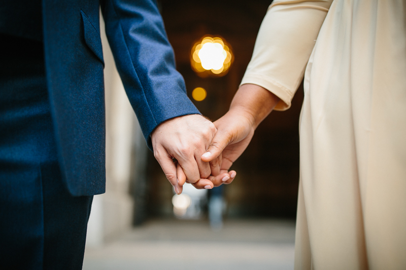 Couple holds hands outside of City Hall Philadelphia after their unique elopement wedding ceremony.