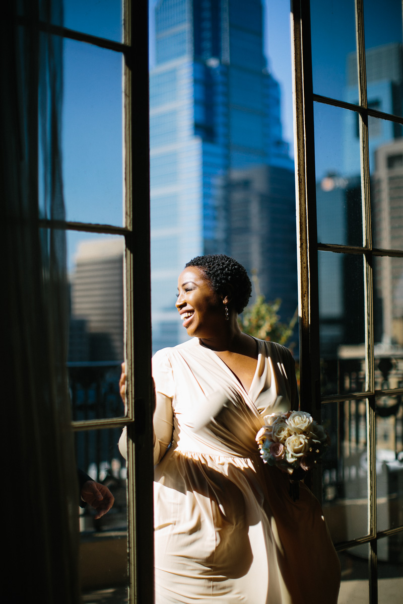 Gorgeous photos of the bride on the Bellevue balcony before her intimate elopement wedding.