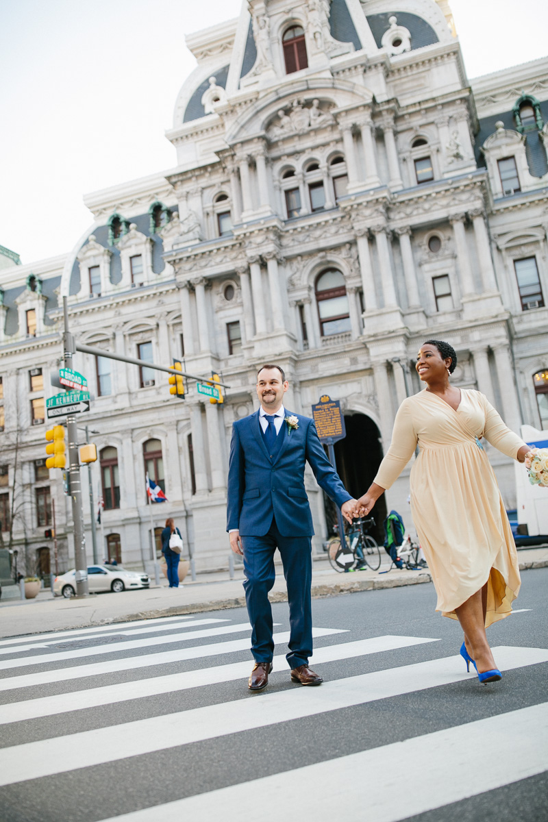 Bride and groom walk down Broad Street in Center City, Philadelphia.
