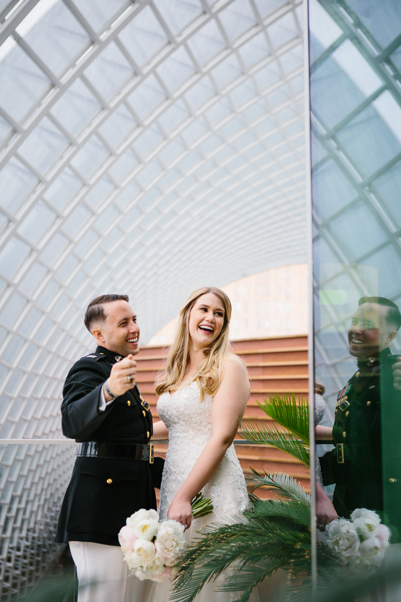 Portraits of the bride and groom at the atrium of Hamilton Garden in the Kimmel.