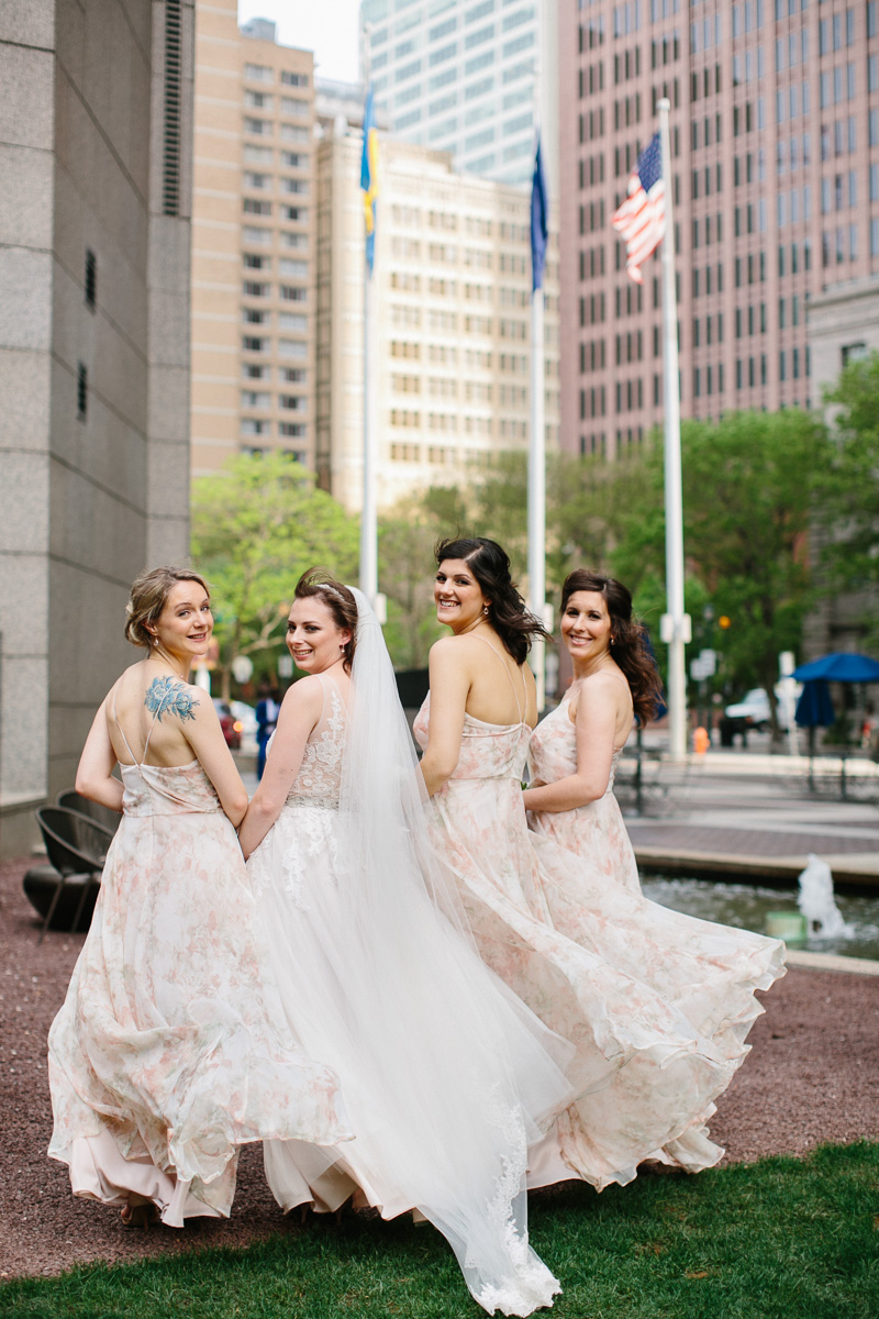 Bride and bridesmaids in soft pink before her modern wedding ceremony.