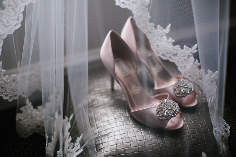 Details of the bride's dress and shoes before her modern wedding ceremony.