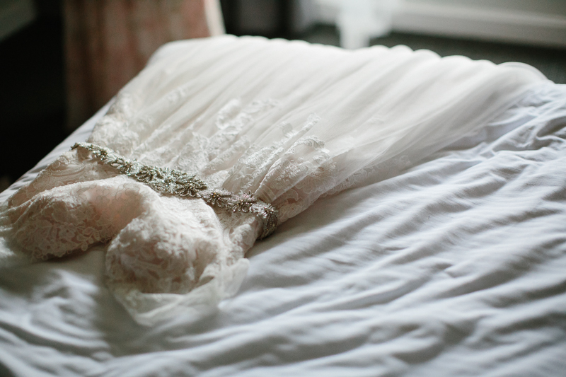 Details of the bride's dress and shoes before her modern wedding ceremony.