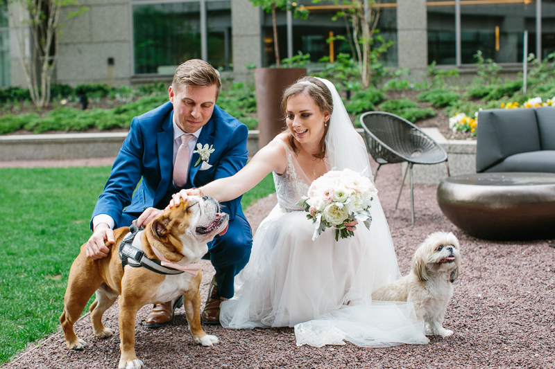 Bride and groom pose for portraits with their bulldog in Philadelphia.
