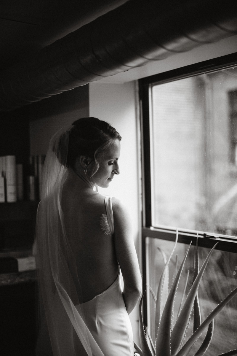Philadelphia bride poses for portraits in her modern cut dress.