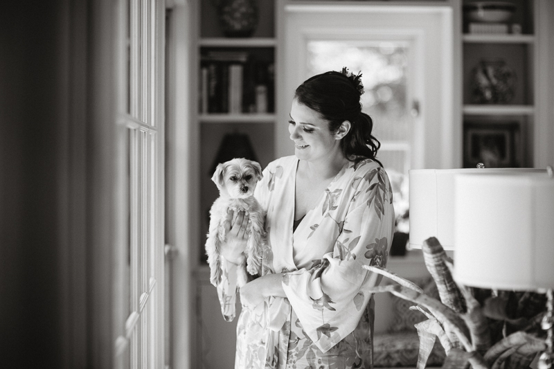 Bride poses with her dog before putting on her wedding dress, outside of Philadelphia.