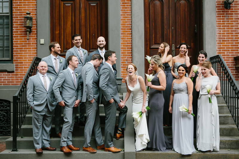 Wedding party stops and poses for portraits in Fitler Square during the spring.