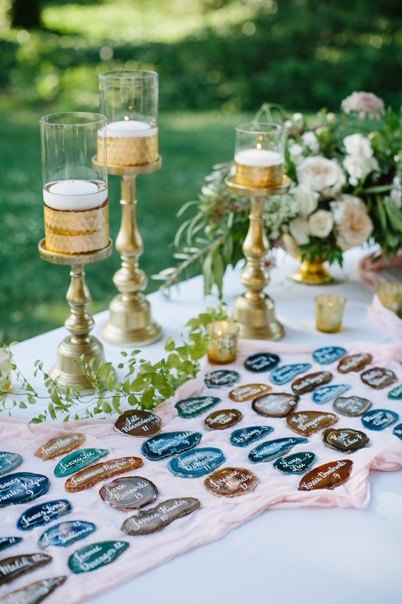 Unique geode table markers with gold details for this outdoor wedding.