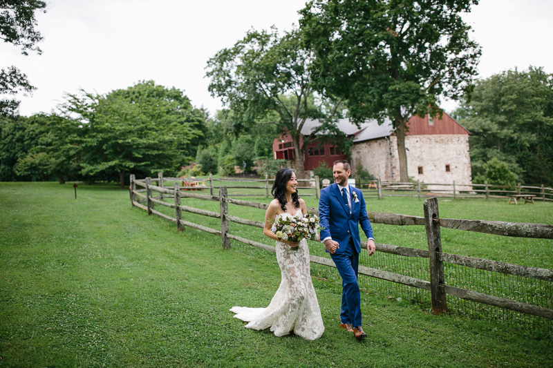 The bride and groom walk around the farm at Grace Winery.